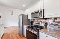 Built-in electric stove top and oven, microwave.  Regrigerator stays, with acceptable offer.