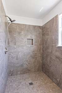 Large walk-in shower in spacious secondary full bathroom off of hallway, situated between Bedrooms 2 and 3.