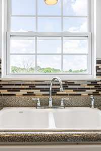 Double, porcelain sink with window overlooking the backyard.