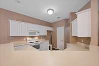 The kitchen has a raised bar area and pantry.