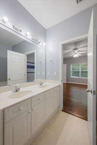 The primary bath has white double vanity.