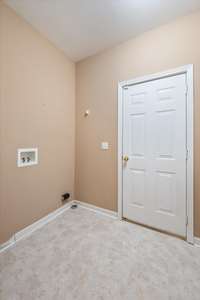 The laundry room also provides access to the side-entry garage with work space and cabinets.