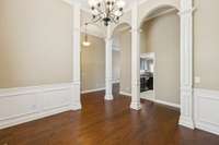 Tall ceilings, columns and detailed trim add to the grand look and feel of the formal dining room.