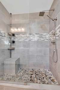 Primary bath has this amazing walk-in shower with a built in bench