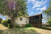 Beautiful shrubs accessorize the exterior of the home making you feel warm and at home.