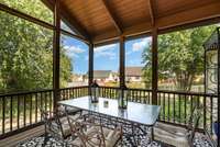 Overlooking the neighborhood, you can enjoy a morning cup of coffee or an evening cup of wine unbothered by the seasonal conditions thanks to the covered pitched roof and the screened in surrounding.