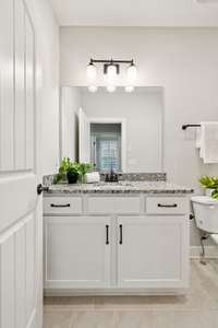 First of 3 full baths for guest use on main level-complete with granite and tub/shower combination