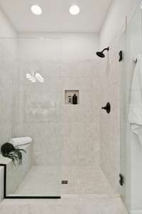 Beautiful walk in tiled shower with spa bench-truly resort style amenities in this lovely home.