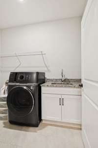 Granite continues into your laundry room. Top of the line dual Washer/Dryer unit will remain