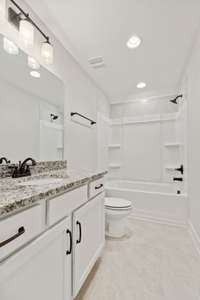 Upper level full bathroom with tub/shower combination and granite countertop