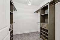 Custom closet organizers provide elegant organization in your owner suite walk-in