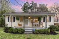 This Charming home has a welcoming front porch with a swing that remains with the property.