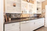 The kitchen has lots of cabinetry that was updated in the renovation in 2018. The window overlooks the second family room at the back of the house.