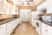 The kitchen includes the dishwasher, range, refrigerator, & microwave.