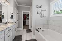 The primary bath features a soaker tub, double sinks, tiled shower and walk in custom closet.