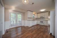 Eat in Kitchen with exterior double doors that lead to the deck. There is also a side door that leads to the driveway.