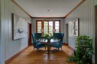 Across from the butler's pantry is this light filled comfortable space. Another enchanting choice of lighting.