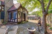 Library -Office also has French doors.  All the window shutters are solid wood original to the home.  Stone patio.