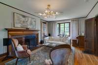 I love the elegance of  chandelier in the living room. So much natural light.