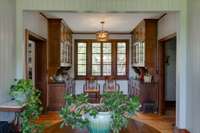 The Butlers Pantry next to the kitchen, original fine furniture grade cabinets with granite counter tops. One door leads to dining room the other leads to kitchen.
