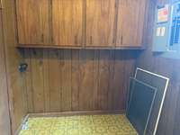 The utility room has storage and plenty of room for folding clothes.