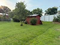 The storage building will stay with the home, and part of the backyard is enclosed with a fence.