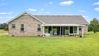 Another view of the back of the house with a covered patio