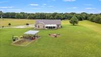 Aerial view of home, pergola and fire pit.
