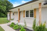 Such a welcoming entrance with a covered rocking chair front porch.