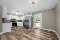 Kitchen/dining combo areas with door leading out to the back deck.