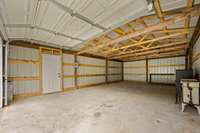 New pedestrian door, electricity is run to this garage but not currently hooked up or in working order.