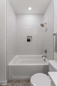 Hall bath with subway tile surround.