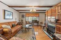 Living room with hardwood floor and beautiful and custom built ins around gas fireplace.