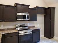 Custom Dark Brown Cabinets and Granite Kitchen Counter Tops. Picture of Previous House.