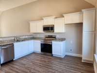 Stainless Smooth Top Stove, Dishwasher & Built-in Microwave. Picture of Previous House.