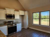 Double Windows and LVP Flooring in the Kitchen & Dining Area.  Picture of Previous House.