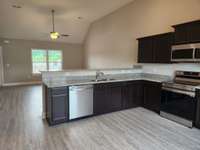 Living Room and Kitchen have LV Plank Flooring.  Picture of Similar House.