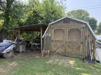 Wooden shed and lean-to shed stay with the house