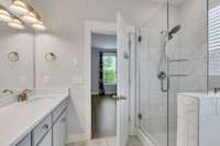 PRIMARY BATHROOM WITH TILE SHOWER AND SEPARATE TUB