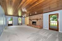 Living Room- carpet, fireplace with gas logs, wood ceiling, ceiling fan, crown molding, recessed lighting