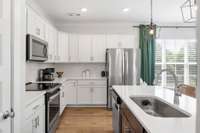 The island has an amazing sink, storage and stainless dishwasher.