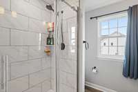 Primary bathroom shower (only)...tiled to the ceiling.