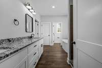 Primary bathroom with granite countertops and double sinks