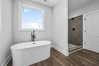 Primary bathroom tile shower and soaker tub