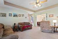 Entering through the front door to a generous living room with Tray Ceilings