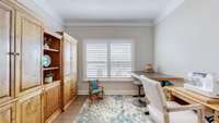 Bedroom 2 features crown molding, hardwood floors, and plantation shutters.
