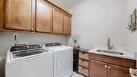 The laundry was upgraded with 36" cabinets and a sink.