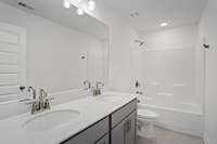 Picture of model home and not of actual home being built.  Colors and selections may vary.  Pick the colors and selections you desire with this presale opportunity.  This option available in secondary bath with separate sink vanity.  Quartz included