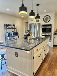 Love the touch that the lighting and all the fixtures add in this kitchen