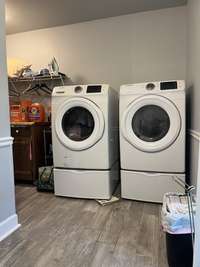 A big L shaped laundry room with storage, folding station